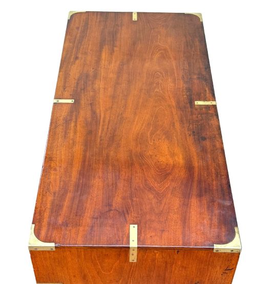 fig 1. A mid-19th century camphor wood military campaign chest of drawers featuring brass corner brackets, flush handles, and two separate stacking sections on turned feet.