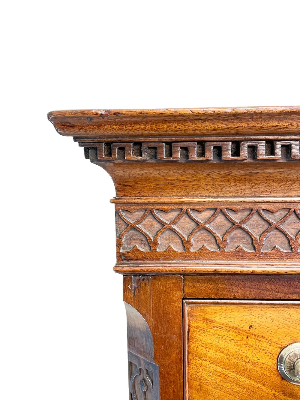An 18th-century Georgian mahogany chest on chest featuring graduated drawers, carved fretwork, dentil moulding, and brass handles. View II