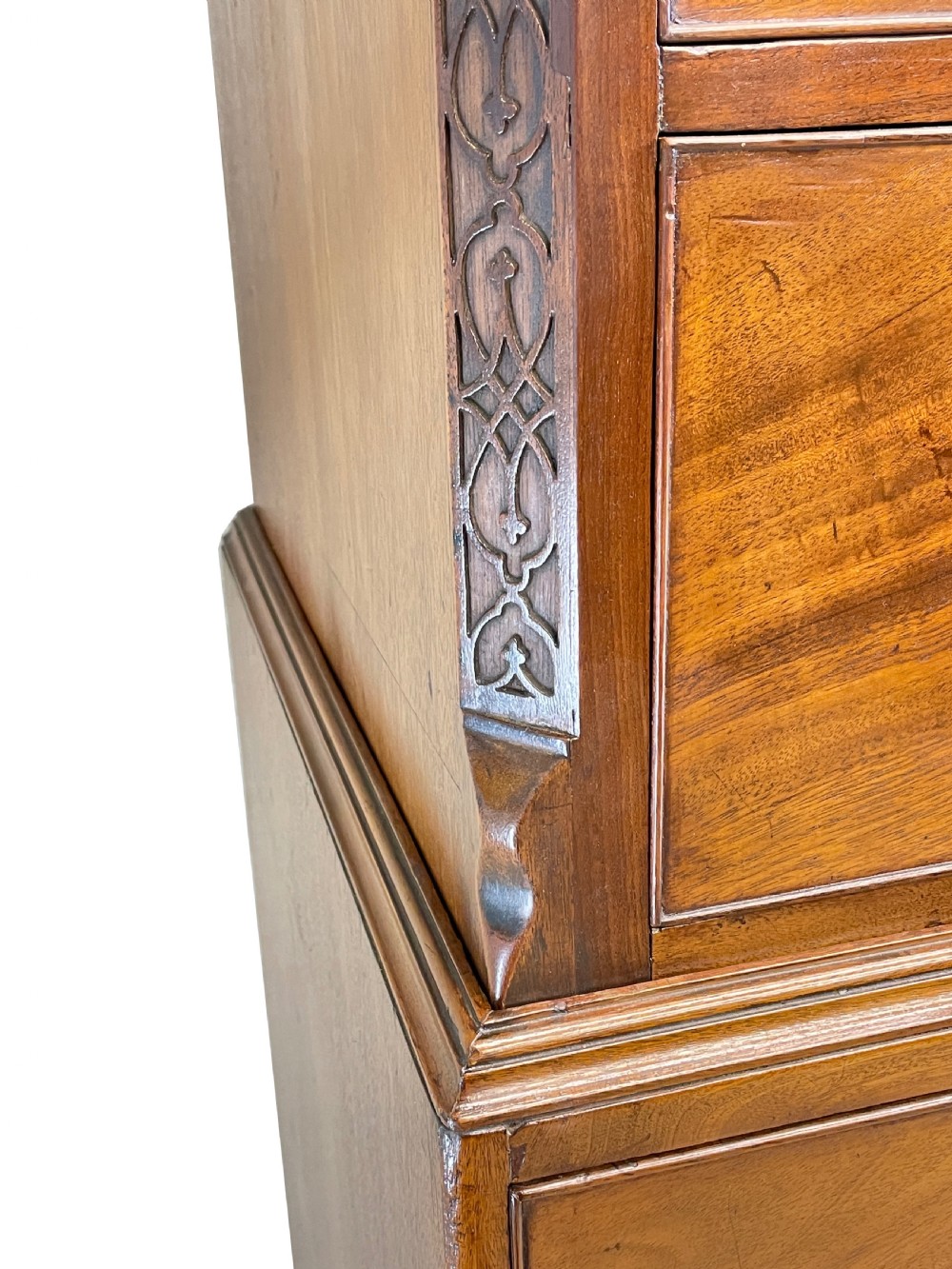 An 18th-century Georgian mahogany chest on chest featuring graduated drawers, carved fretwork, dentil moulding, and brass handles. View XII