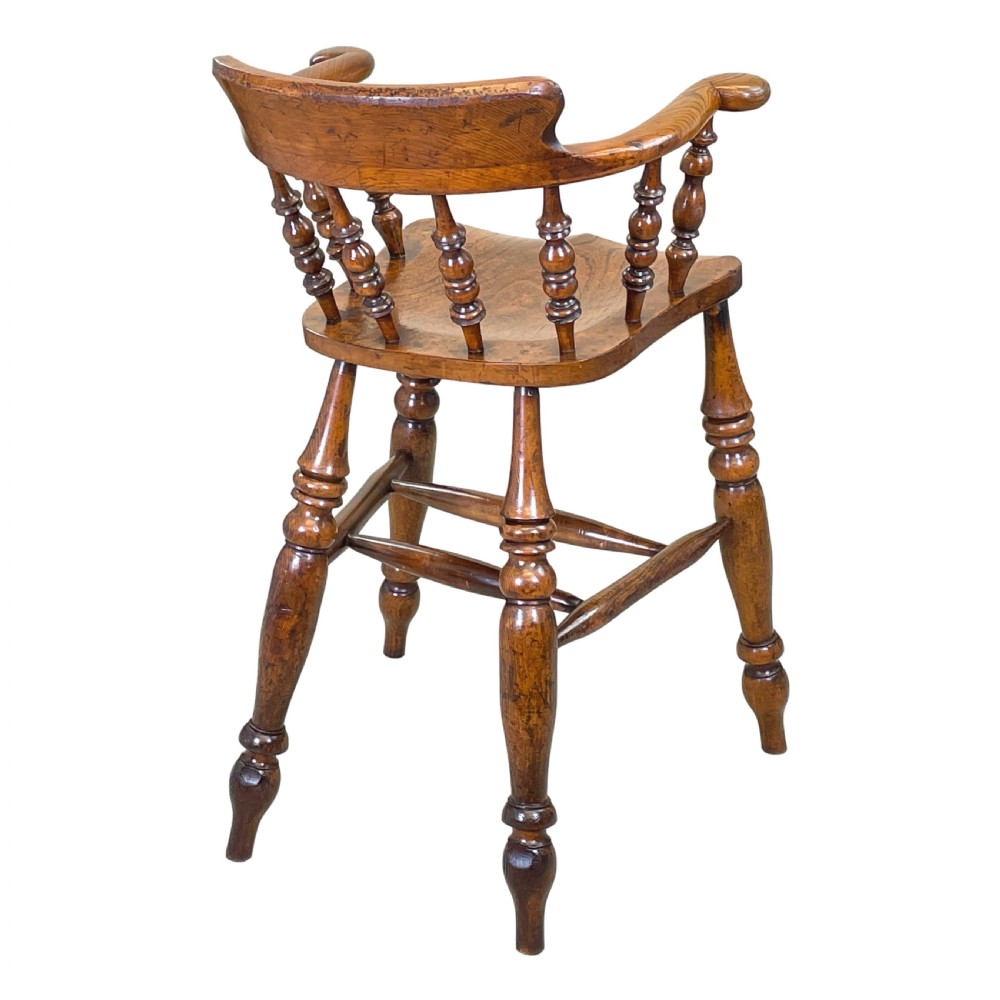 A 19th-century wooden clerk chair featuring a curved horseshoe backrest, turned spindles, a shaped saddle seat, and tall turned legs with double stretchers. View IV