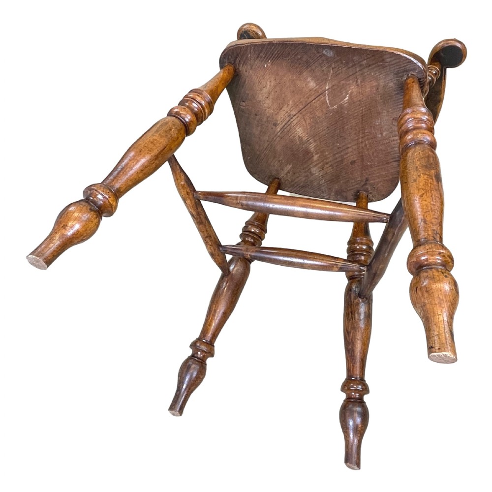 A 19th-century wooden clerk chair featuring a curved horseshoe backrest, turned spindles, a shaped saddle seat, and tall turned legs with double stretchers. View IX