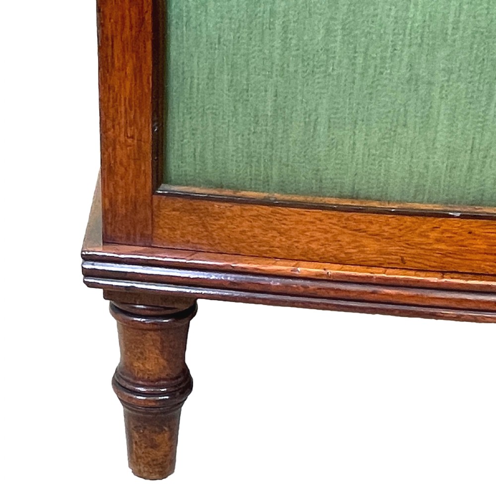 A Regency period bow-fronted mahogany side cabinet featuring two green fabric-panelled doors and turned legs. View V
