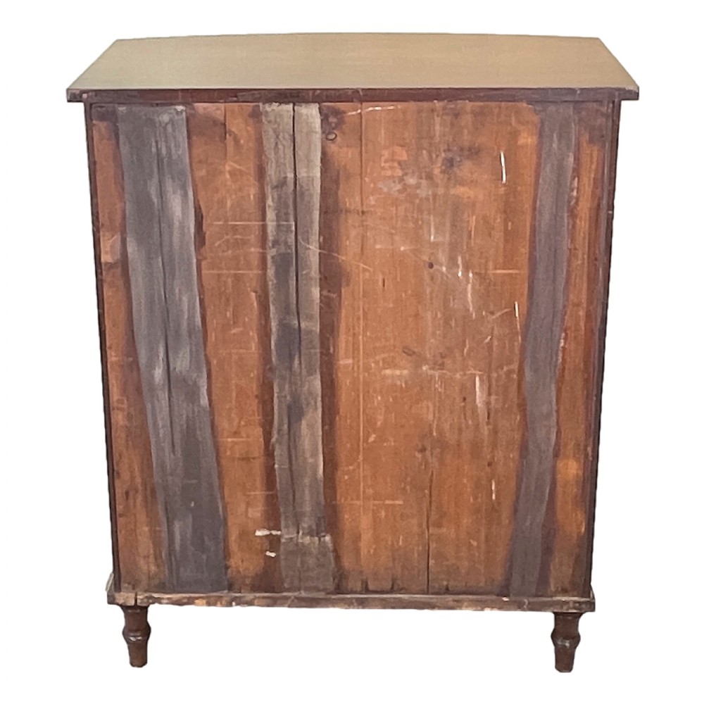 A Regency period bow-fronted mahogany side cabinet featuring two green fabric-panelled doors and turned legs. View VI