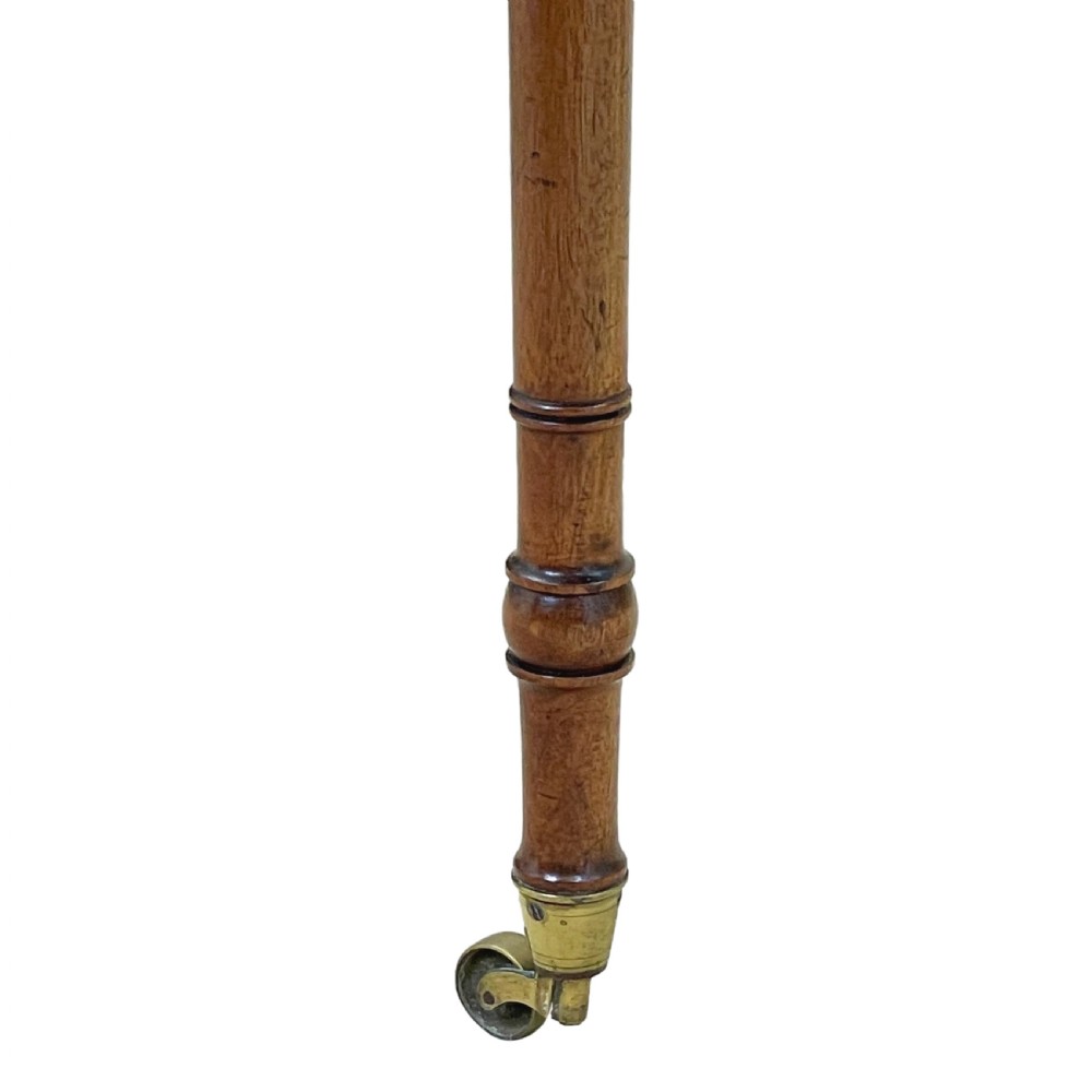 A small Georgian mahogany Pembroke table featuring two drawers with brass handles, fine stringing inlay, two drop leaves, and slender turned legs on brass castors. View VIII