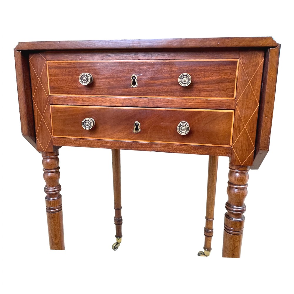 A small Georgian mahogany Pembroke table featuring two drawers with brass handles, fine stringing inlay, two drop leaves, and slender turned legs on brass castors. View IX