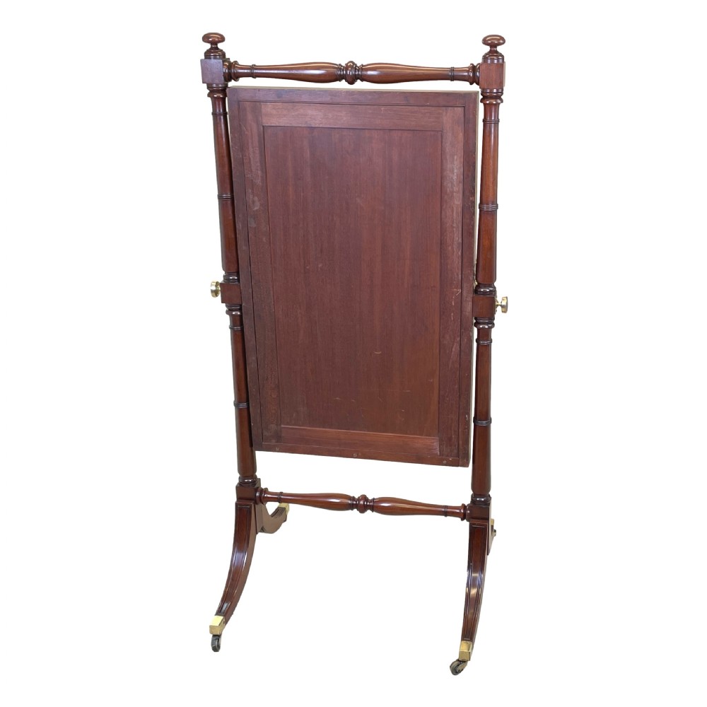 A Georgian mahogany freestanding cheval mirror featuring brass candle sconces, turned upright columns, and splayed legs with brass castors. View VIII