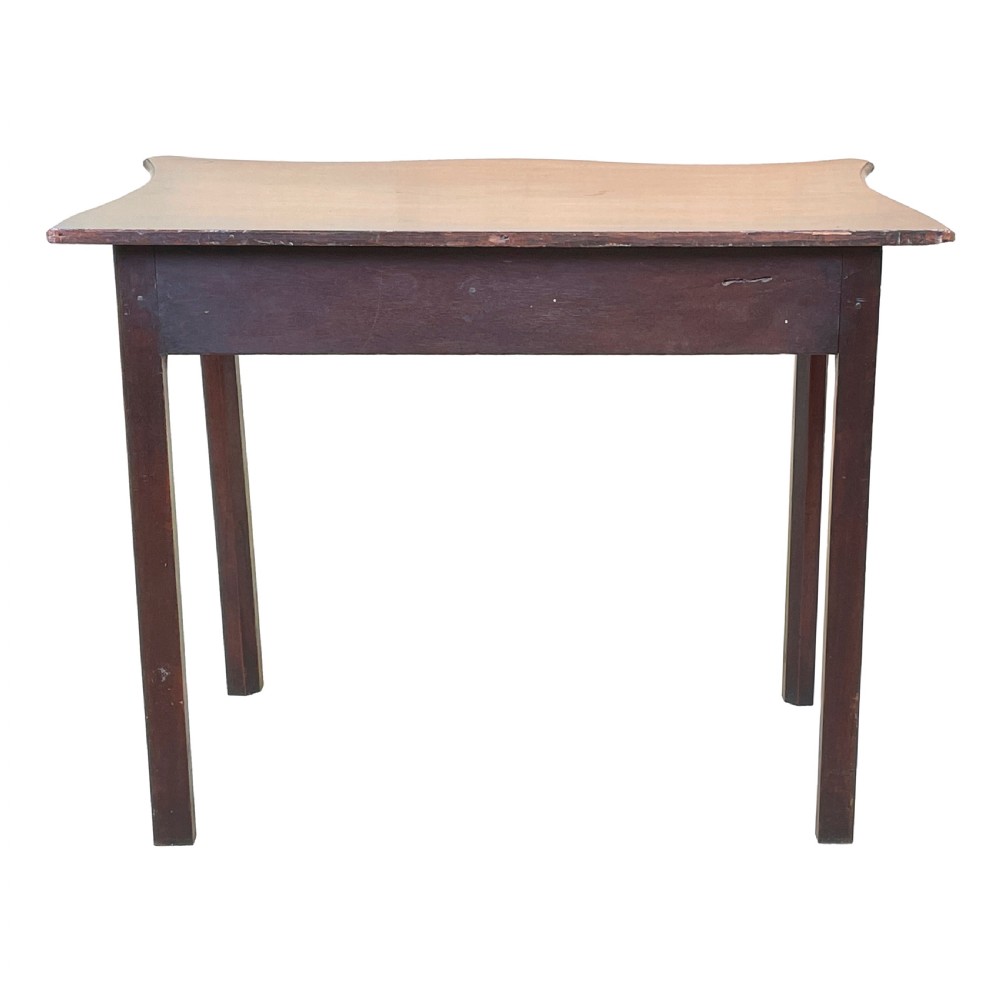 A Georgian mahogany side table featuring a serpentine front, a single drawer with a brass handle, and four straight fluted legs. View IV