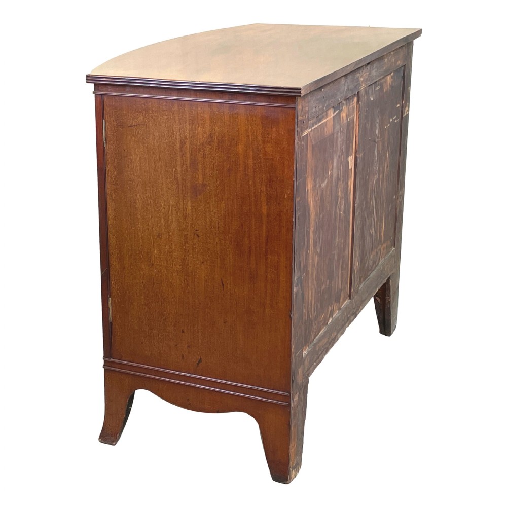 A Georgian bow-front mahogany dwarf cupboard with flame mahogany twin door panels, brass astragal mouldings, and splayed bracket feet. View IV