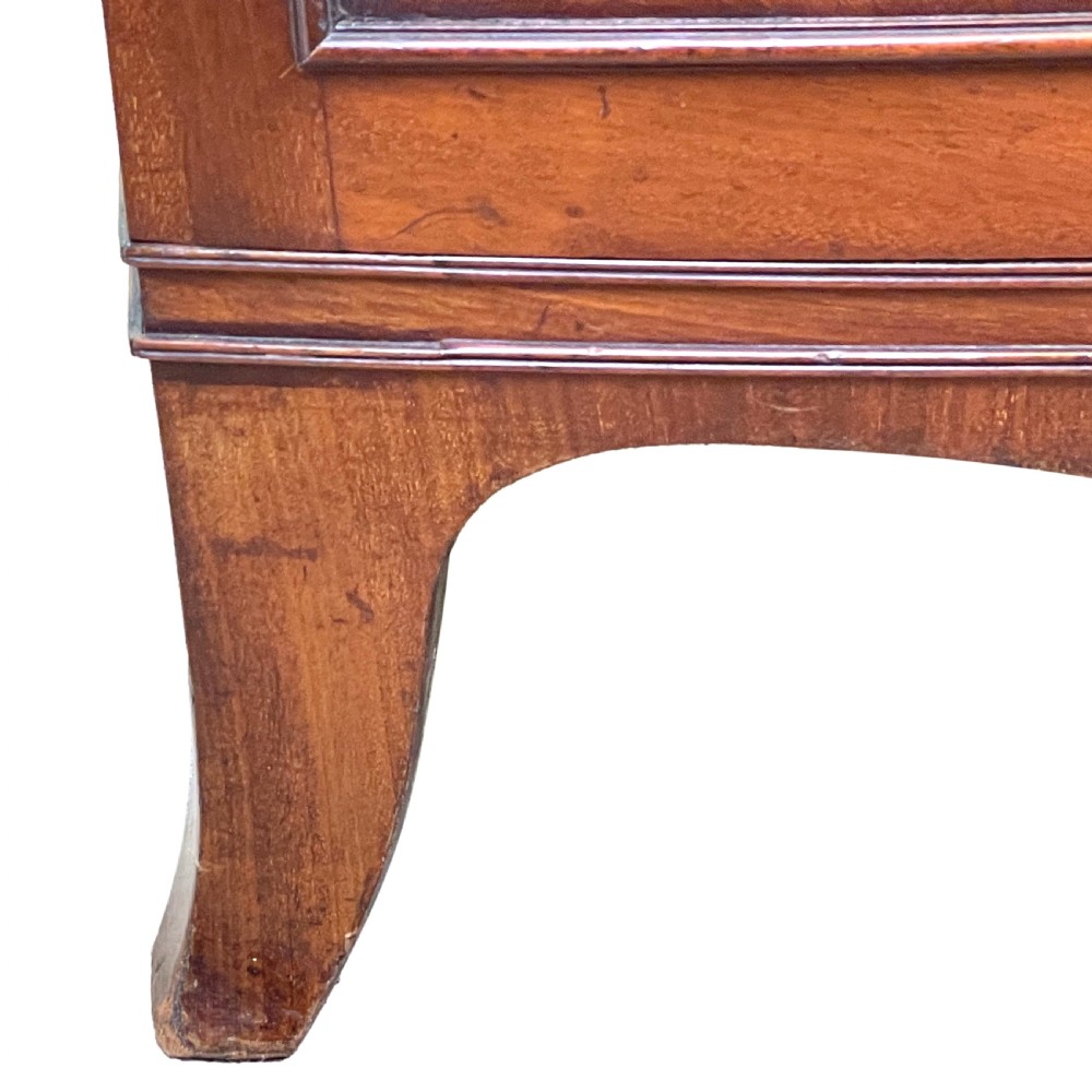 A Georgian bow-front mahogany dwarf cupboard with flame mahogany twin door panels, brass astragal mouldings, and splayed bracket feet. View IX