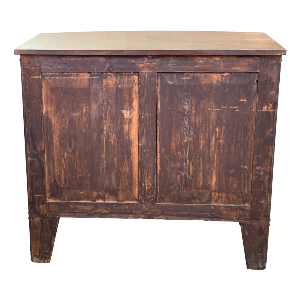 A Georgian bow-front mahogany dwarf cupboard with flame mahogany twin door panels, brass astragal mouldings, and splayed bracket feet. View X