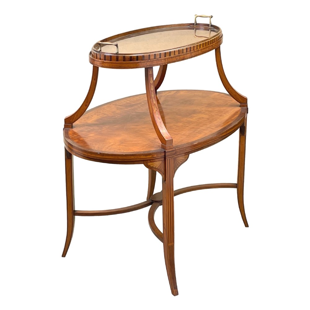 A 19th-century oval satinwood two-tier etagere table featuring geometric stringing inlay, a removable brass-handled upper tray, and outswept legs joined by an X-stretcher. View II