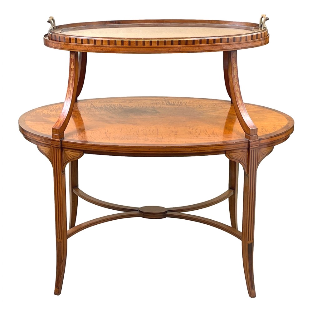 A 19th-century oval satinwood two-tier etagere table featuring geometric stringing inlay, a removable brass-handled upper tray, and outswept legs joined by an X-stretcher. View V