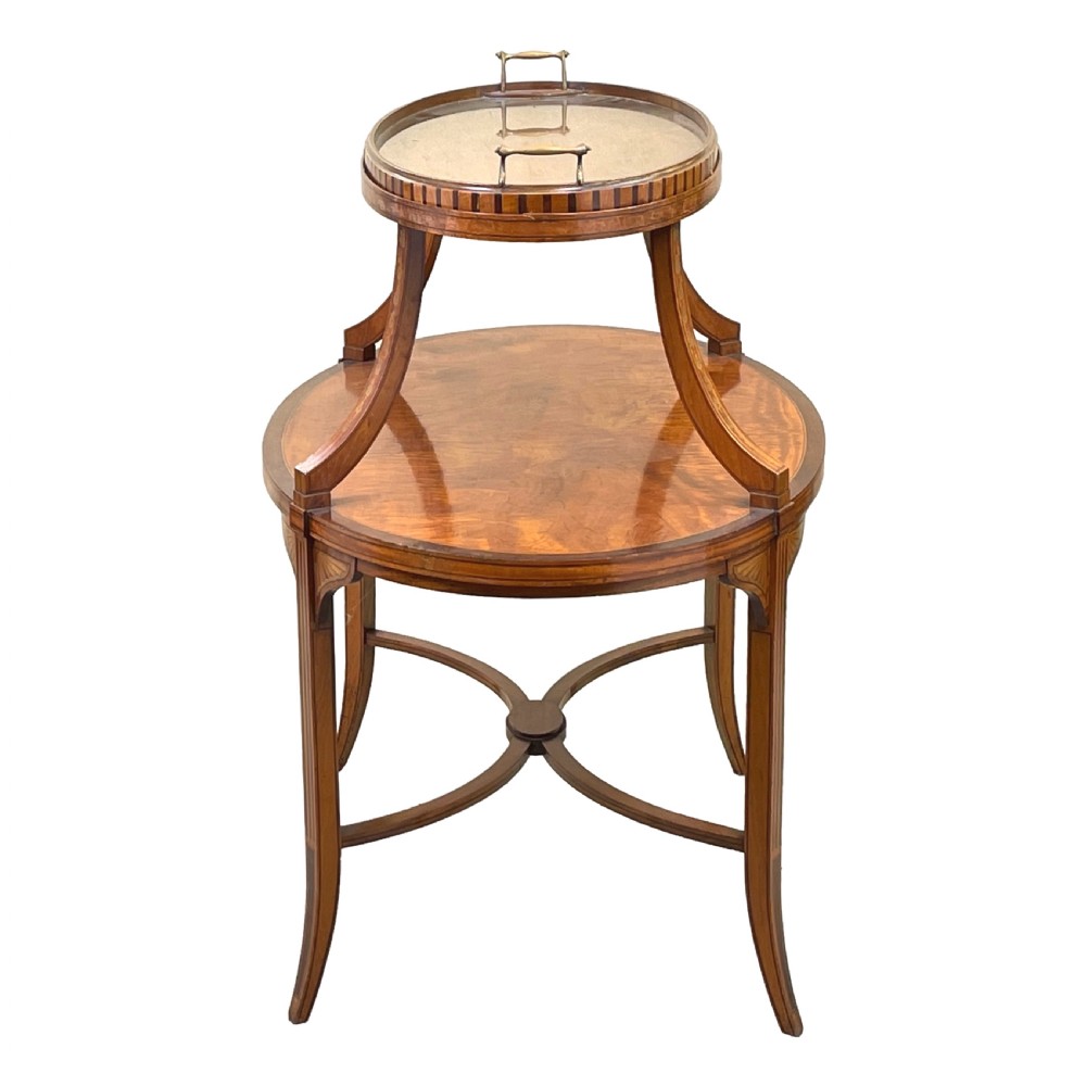 A 19th-century oval satinwood two-tier etagere table featuring geometric stringing inlay, a removable brass-handled upper tray, and outswept legs joined by an X-stretcher. View VII