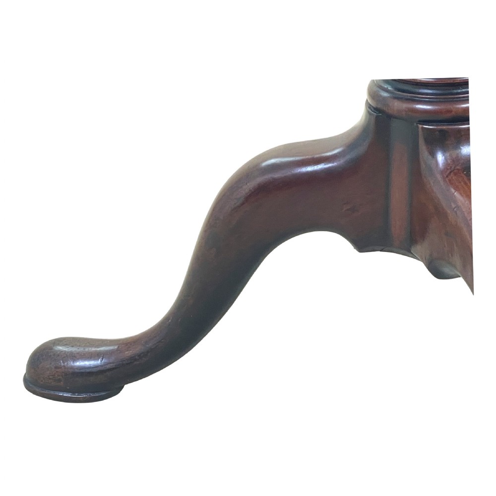 A Georgian mahogany circular dumbwaiter table featuring two graduated tiers raised on a central turned stem and tripod legs. View III