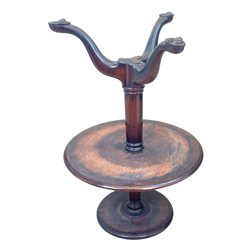 A Georgian mahogany circular dumbwaiter table featuring two graduated tiers raised on a central turned stem and tripod legs. View IV