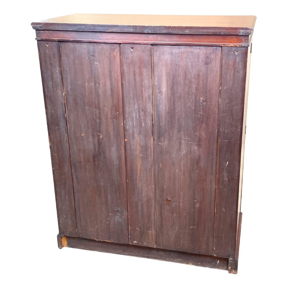 A tall Victorian mahogany double Wellington chest featuring twelve drawers arranged in two parallel columns with turned wooden knobs and side locking stiles. View VI