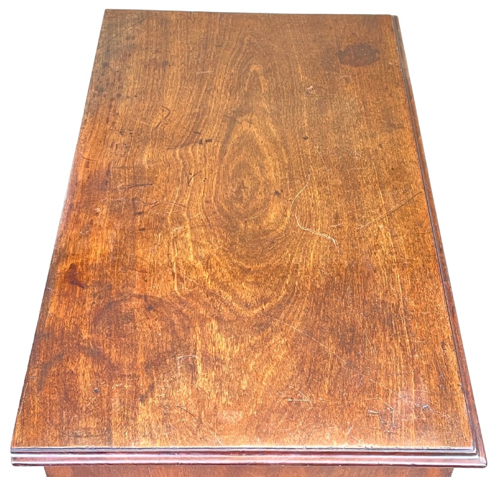 A Georgian mahogany chest of drawers featuring a two-over-three drawer arrangement with brass swan-neck handles and bracket feet. View III