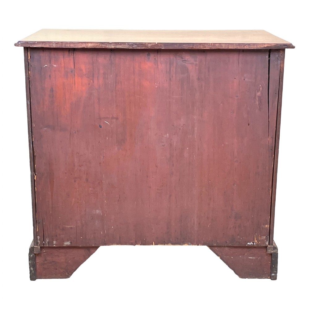 A Georgian mahogany chest of drawers featuring a two-over-three drawer arrangement with brass swan-neck handles and bracket feet. View VII