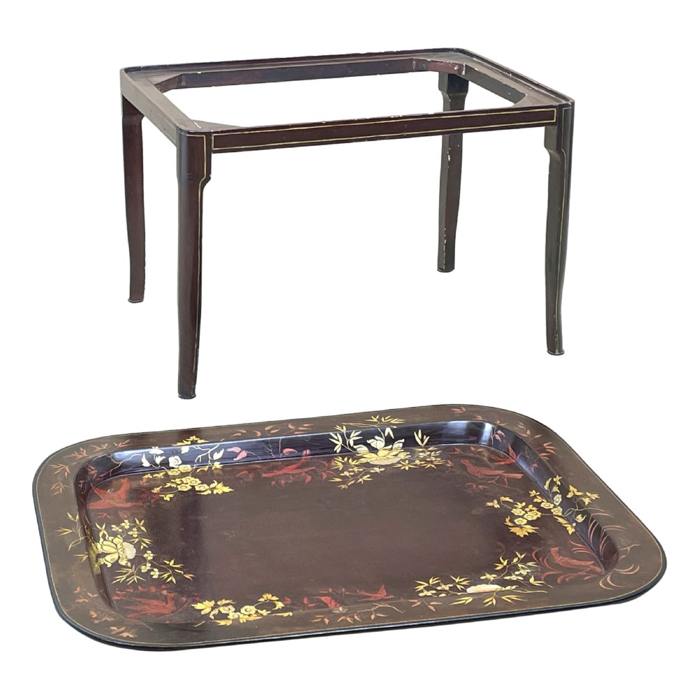 A nineteenth-century dark lacquered papier-mache tray with gold floral decoration resting on a fitted dark wood stand with slender tapered legs. View III