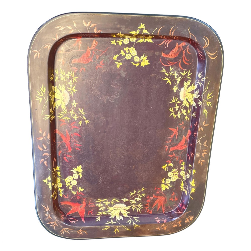 A nineteenth-century dark lacquered papier-mache tray with gold floral decoration resting on a fitted dark wood stand with slender tapered legs. View V