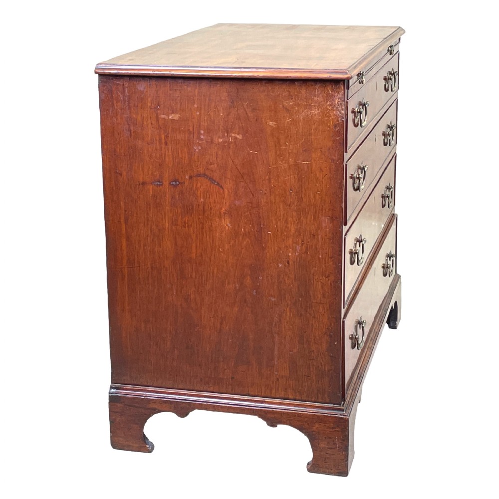 An 18th-century Georgian mahogany chest of drawers featuring four graduated drawers with brass swan-neck handles, a pull-out brushing slide, and bracket feet. View II