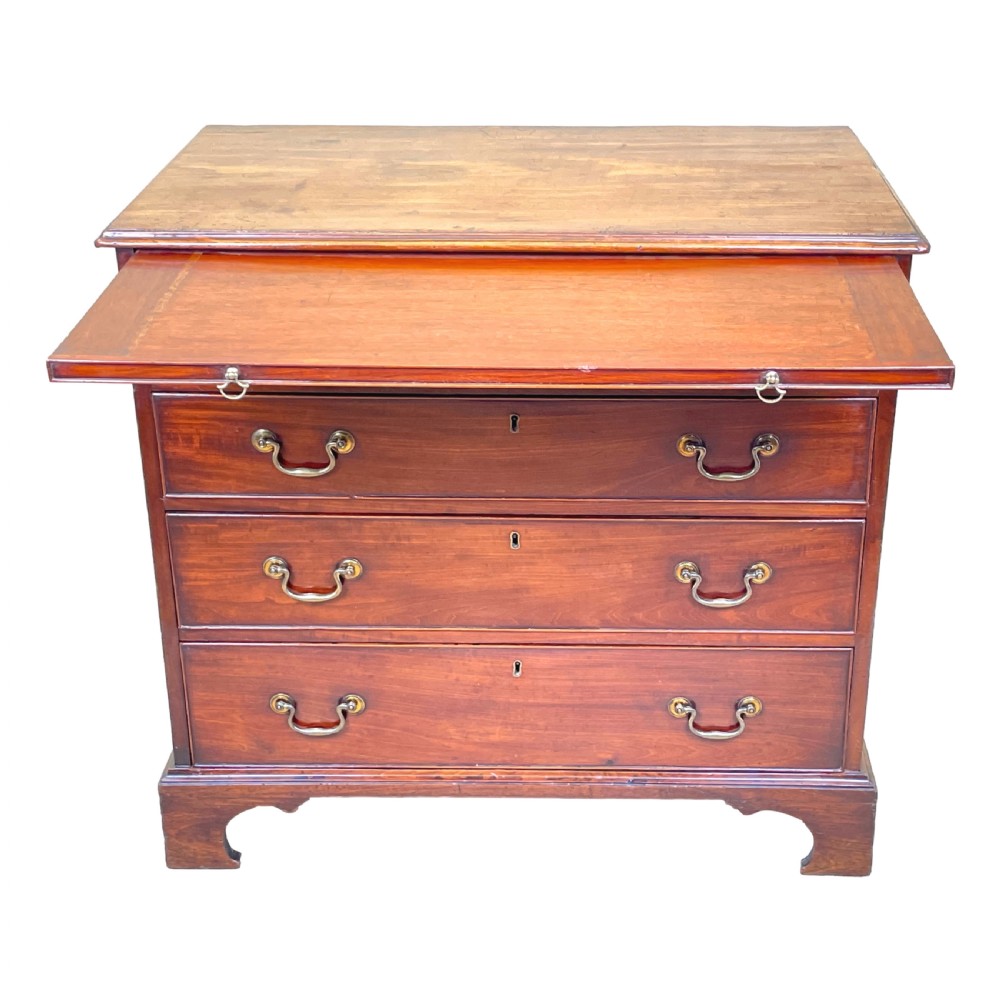 An 18th-century Georgian mahogany chest of drawers featuring four graduated drawers with brass swan-neck handles, a pull-out brushing slide, and bracket feet. View IV