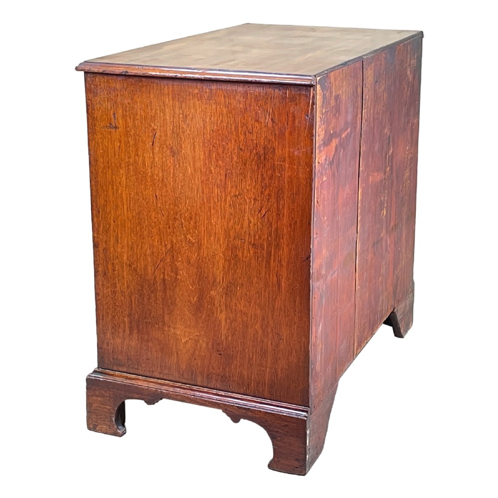 An 18th-century Georgian mahogany chest of drawers featuring four graduated drawers with brass swan-neck handles, a pull-out brushing slide, and bracket feet. View VII