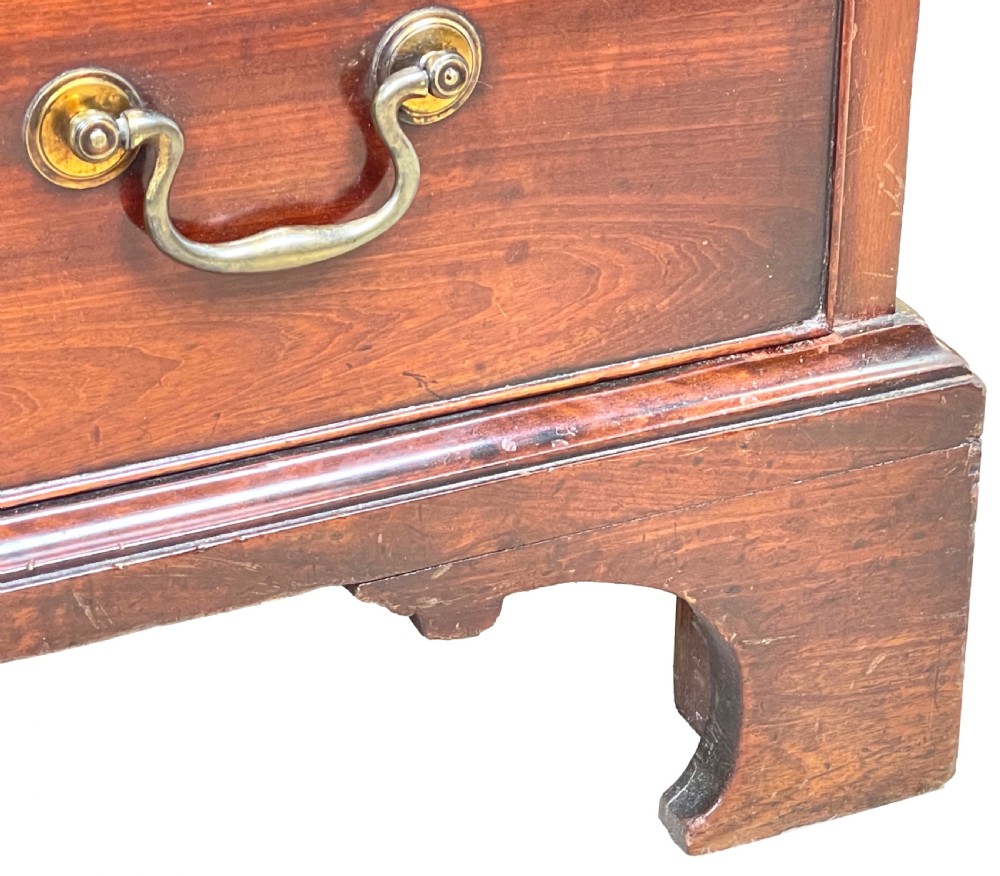 An 18th-century Georgian mahogany chest of drawers featuring four graduated drawers with brass swan-neck handles, a pull-out brushing slide, and bracket feet. View VIII