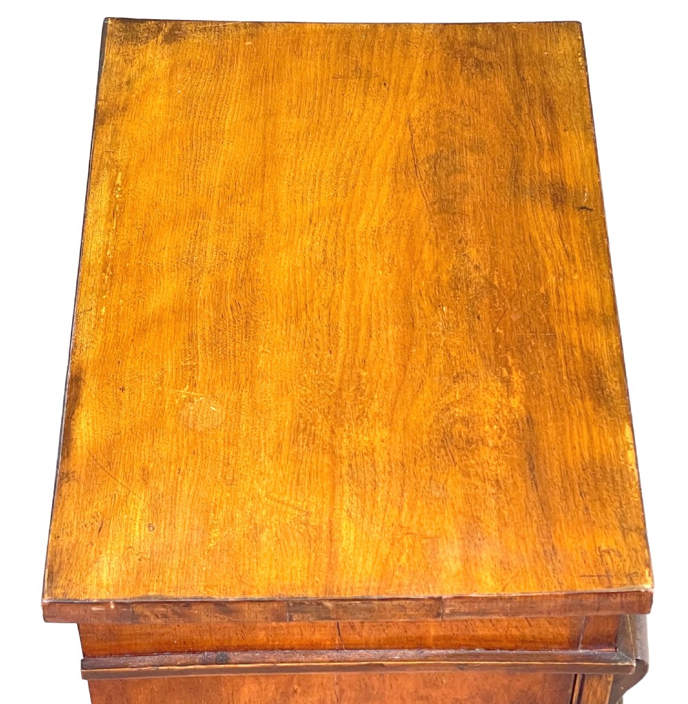 A 19th-century satinbirch childs Wellington chest featuring eight graduating drawers, turned handles, a plinth base, and a side-locking bar. View II