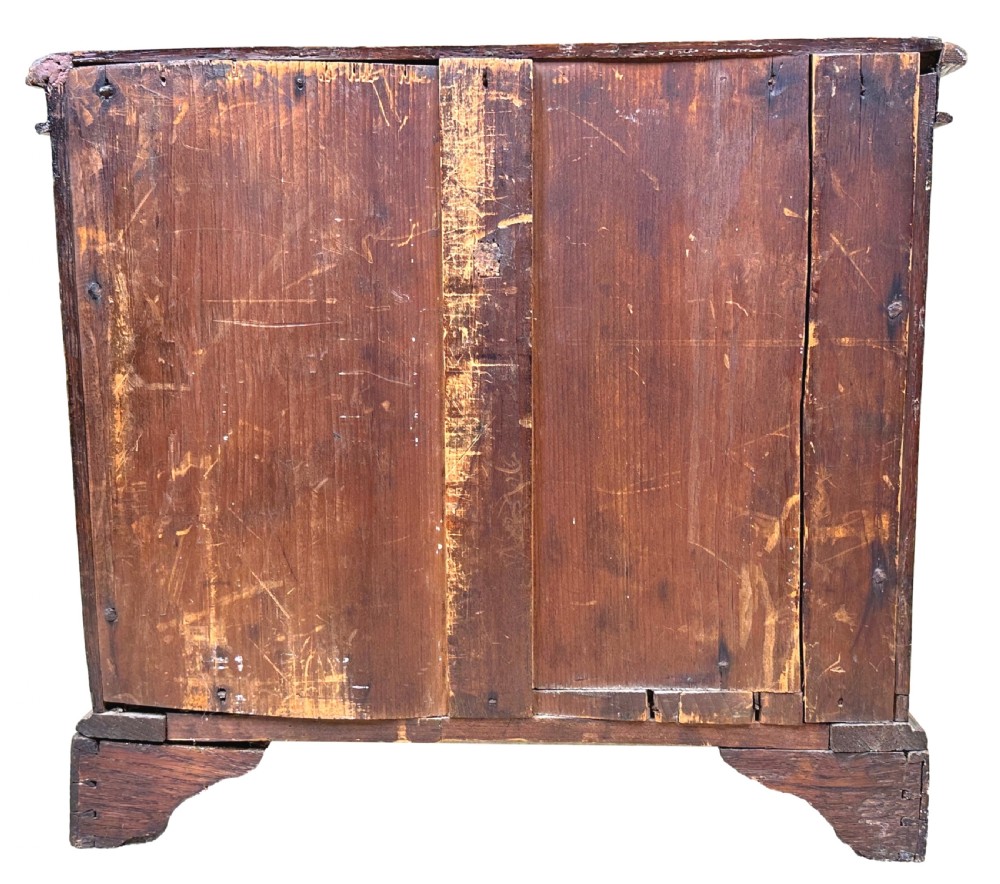A Georgian oak miniature chest of drawers featuring two short over three long drawers with wooden knobs, turned half-columns, and bracket feet. View VIII