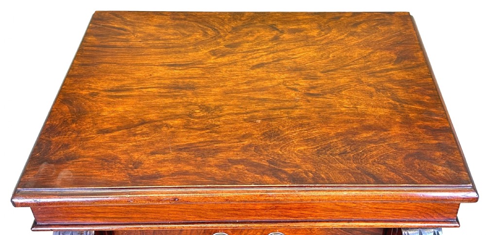 A 19th-century Victorian walnut Wellington chest featuring seven graduated drawers, carved top corbels, and a right-hand hinged locking pilaster. View VI