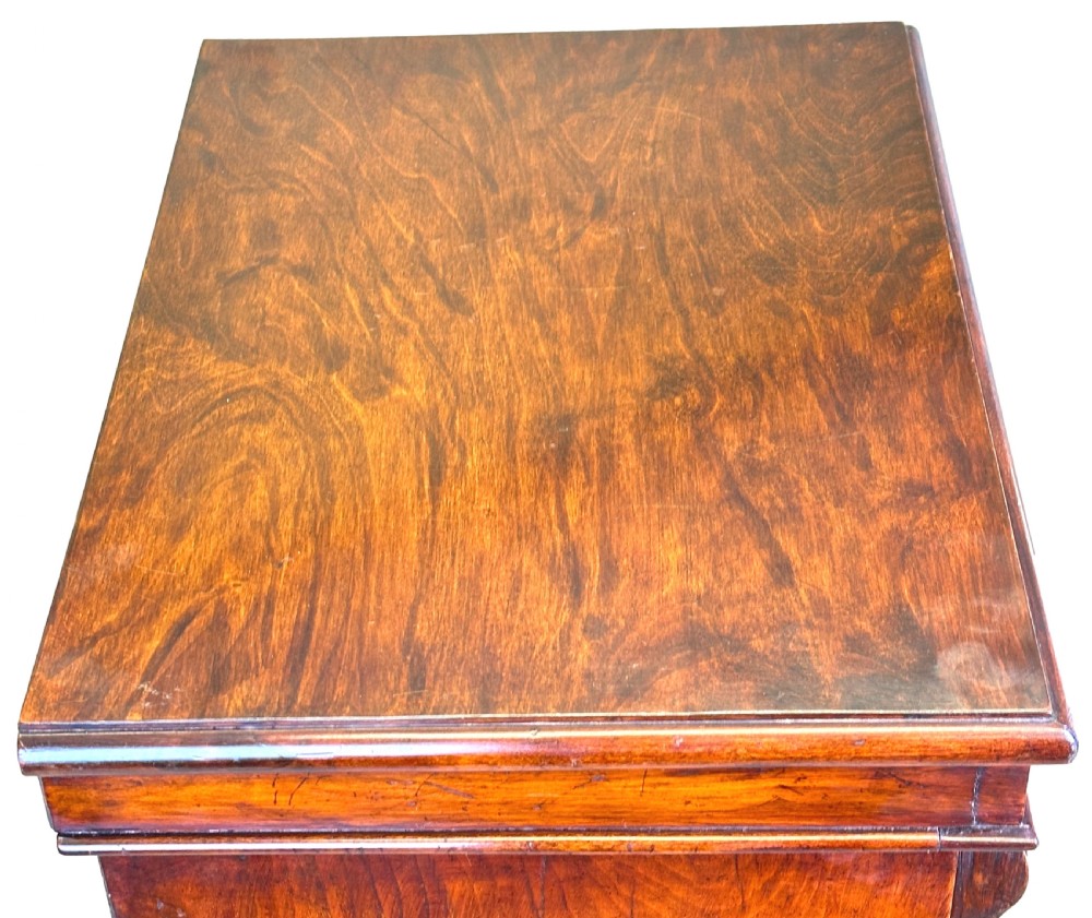 A 19th-century Victorian walnut Wellington chest featuring seven graduated drawers, carved top corbels, and a right-hand hinged locking pilaster. View XI