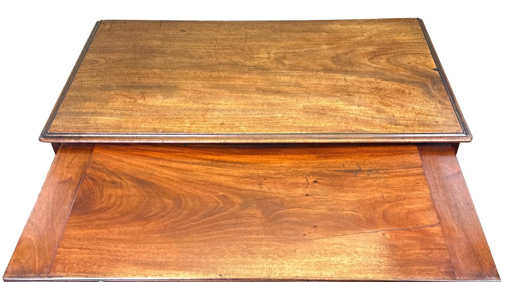 An 18th-century Georgian mahogany kneehole desk featuring brass swan-neck handles, a central recessed cupboard, a pull-out brushing slide, and bracket feet. View III