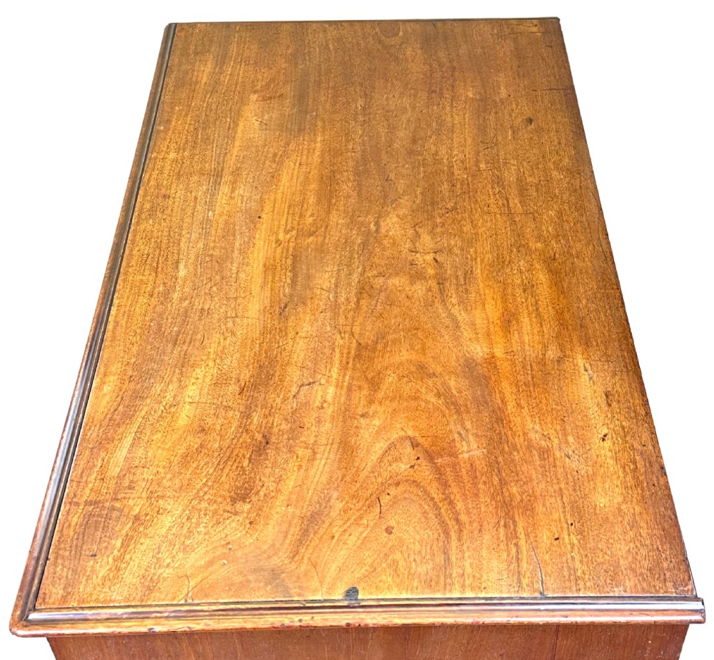 An 18th-century Georgian mahogany kneehole desk featuring brass swan-neck handles, a central recessed cupboard, a pull-out brushing slide, and bracket feet. View VII