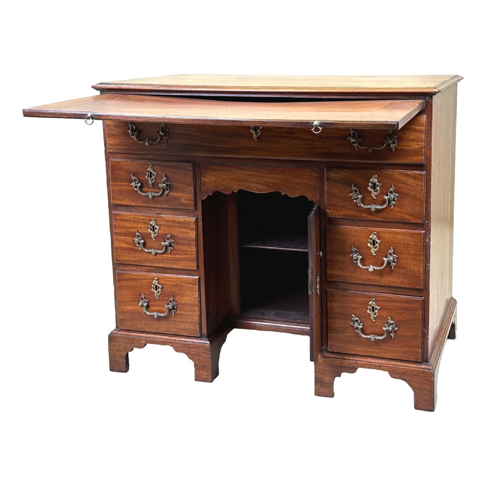 An 18th-century Georgian mahogany kneehole desk featuring brass swan-neck handles, a central recessed cupboard, a pull-out brushing slide, and bracket feet. View VIII