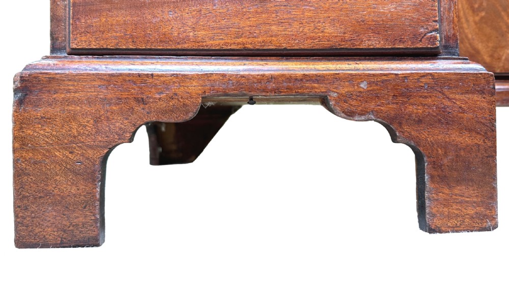 An 18th-century Georgian mahogany kneehole desk featuring brass swan-neck handles, a central recessed cupboard, a pull-out brushing slide, and bracket feet. View X