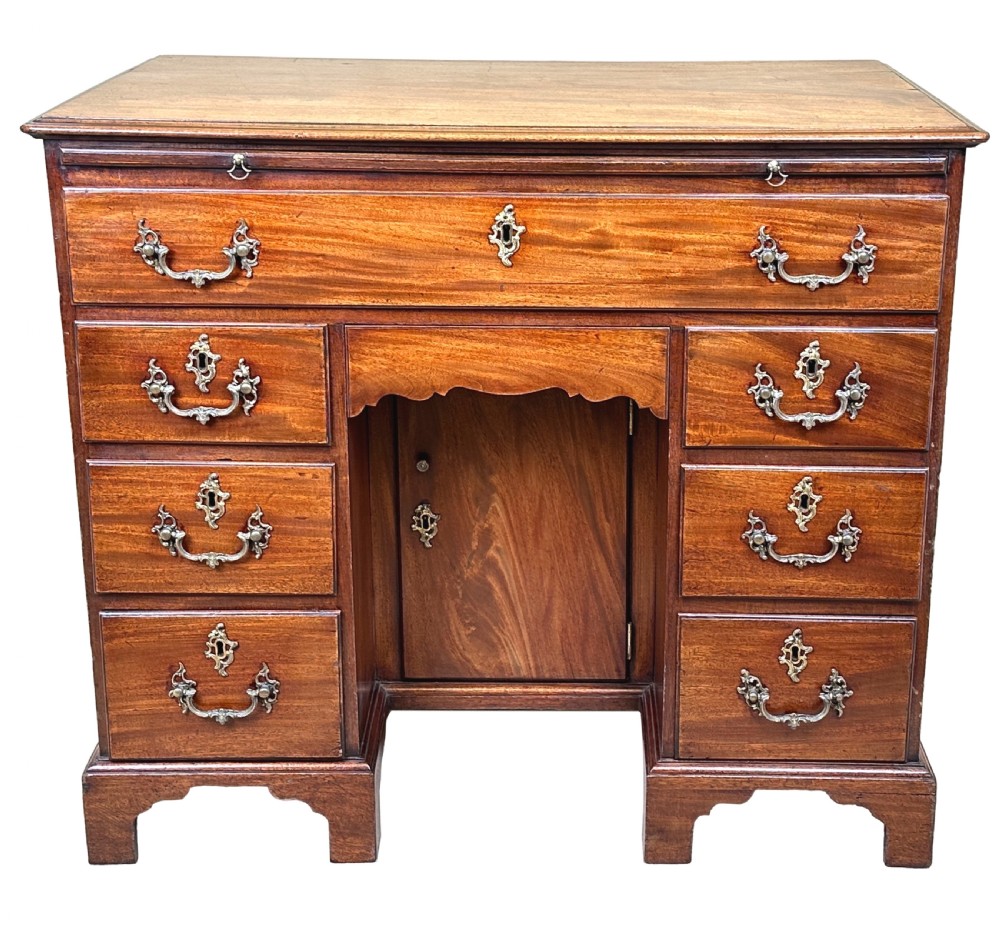 An 18th-century Georgian mahogany kneehole desk featuring brass swan-neck handles, a central recessed cupboard, a pull-out brushing slide, and bracket feet. View XIII