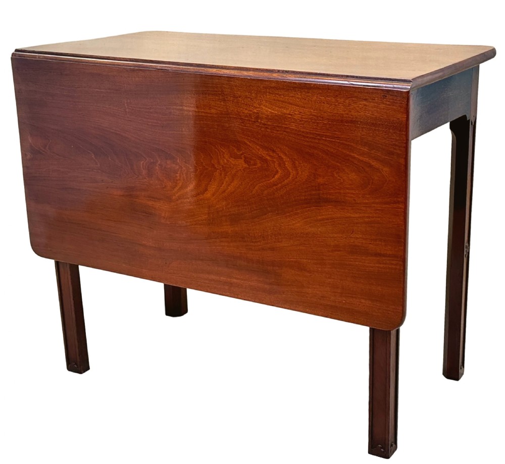 An 18th-century Georgian mahogany drop flap side table featuring a single drawer with a brass handle and carved square legs. View II