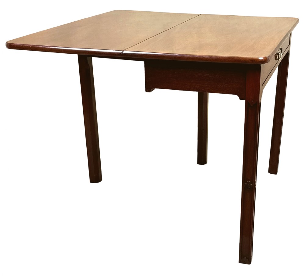 An 18th-century Georgian mahogany drop flap side table featuring a single drawer with a brass handle and carved square legs. View IV