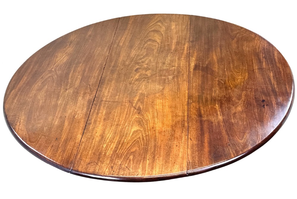 A Georgian dark mahogany drop-leaf dining table with an oval top and tapered legs featuring pad feet. View III