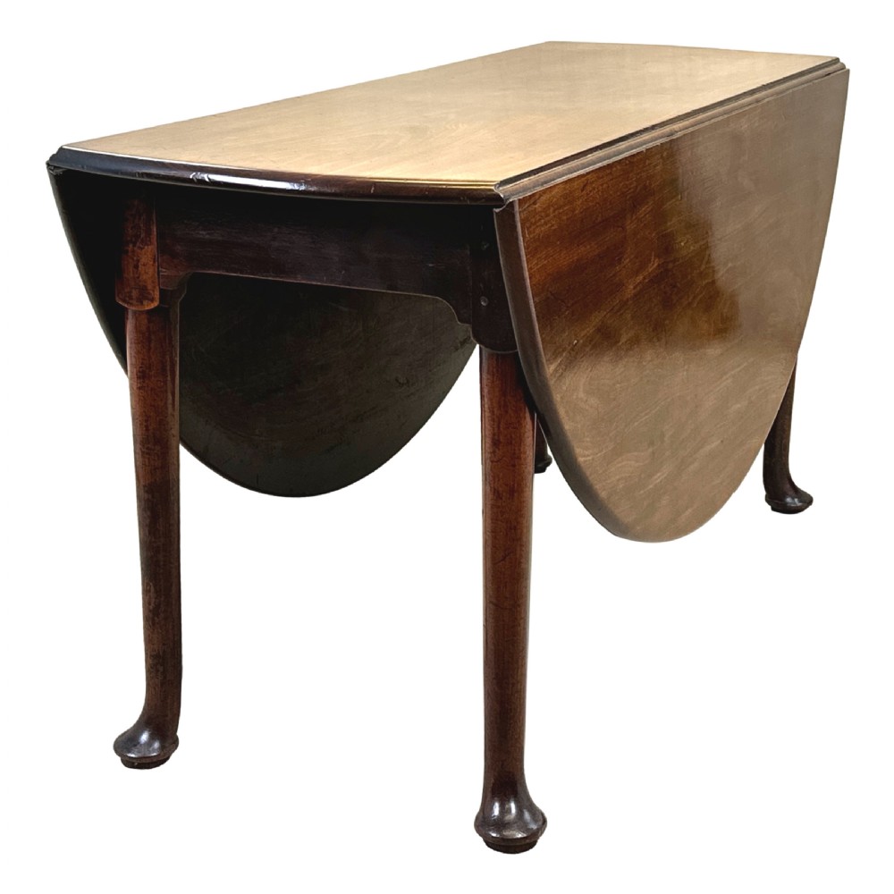 A Georgian dark mahogany drop-leaf dining table with an oval top and tapered legs featuring pad feet. View IV