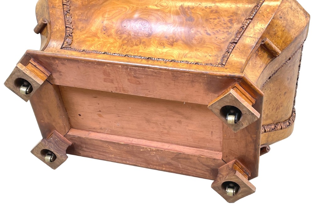 An antique sarcophagus-shaped burr elm cellarette with a carved top finial, gadrooned moulding, and a brass keyhole escutcheon. View XIII