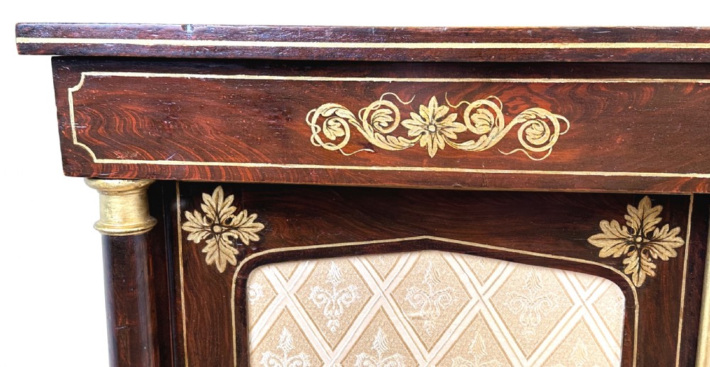 A Regency simulated rosewood side cabinet with gilded floral details, fabric door inserts, side columns, and gilded lion paw feet. View III