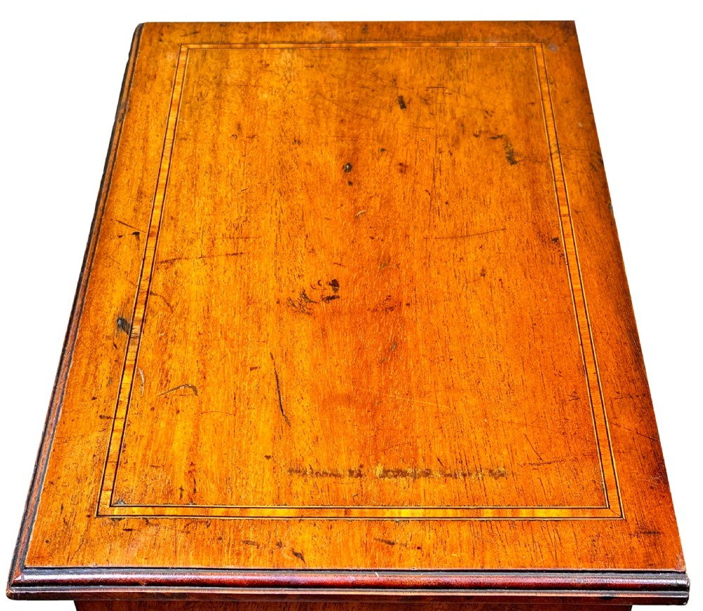 A 19th-century walnut miniature chest of five graduated drawers featuring inlaid crossbanded borders and turned handles on a solid plinth base. View III