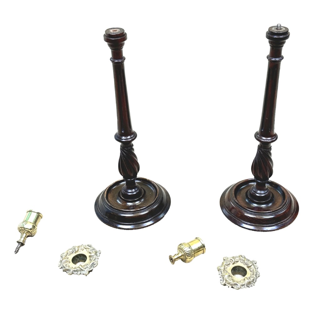 A pair of late 19th-century turned dark mahogany candlesticks featuring spiral twist shafts and polished brass sconces. View VI