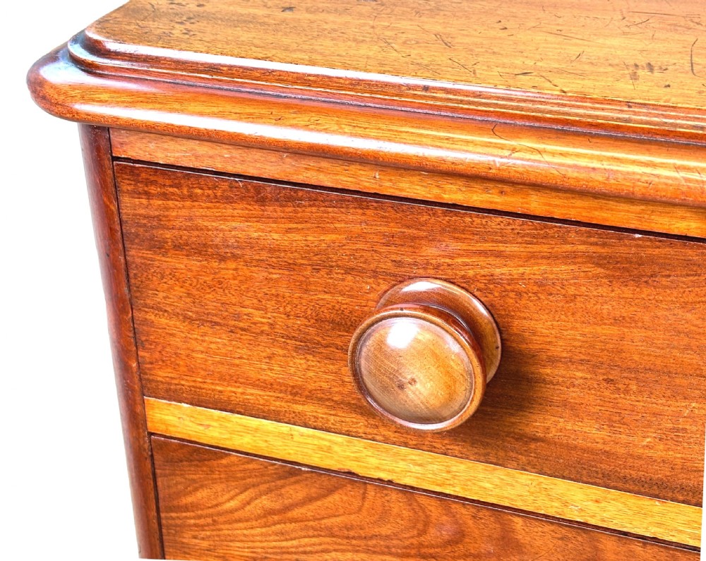 A 19th-century Victorian mahogany chest featuring five graduated drawers with turned wooden knobs and a solid plinth base. View IV