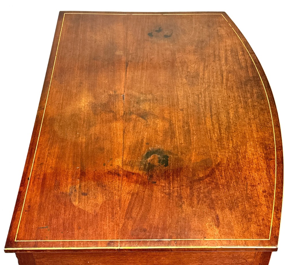 An 18th-century Georgian mahogany dressing table featuring decorative boxwood stringing, three drawers with circular knobs, an arched kneehole, and square tapered legs. View V