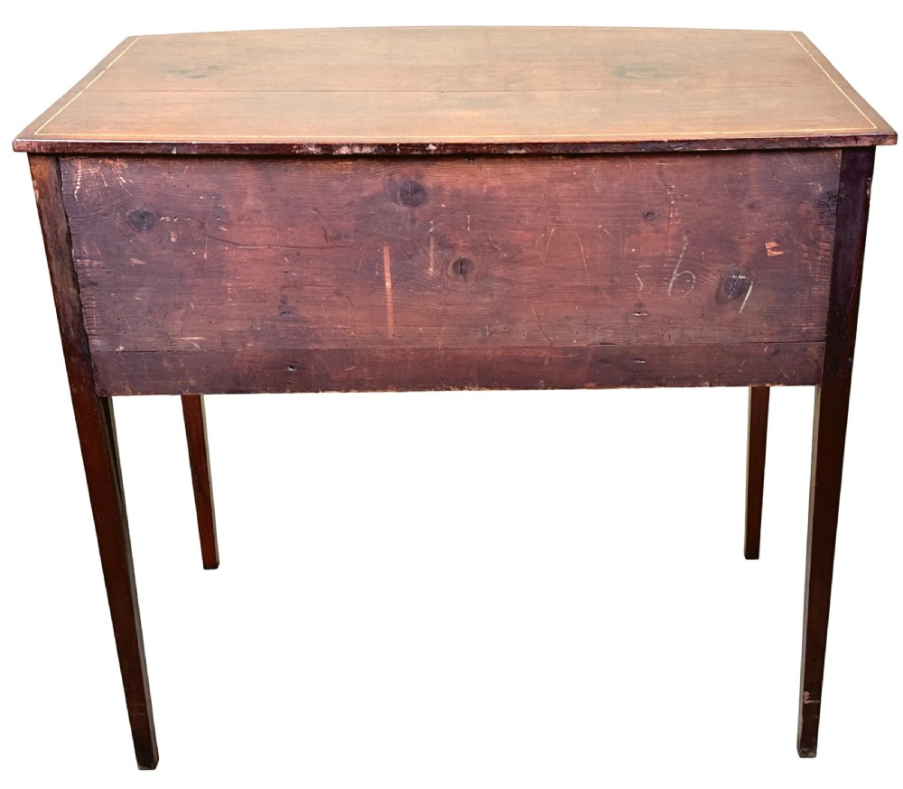 An 18th-century Georgian mahogany dressing table featuring decorative boxwood stringing, three drawers with circular knobs, an arched kneehole, and square tapered legs. View VIII