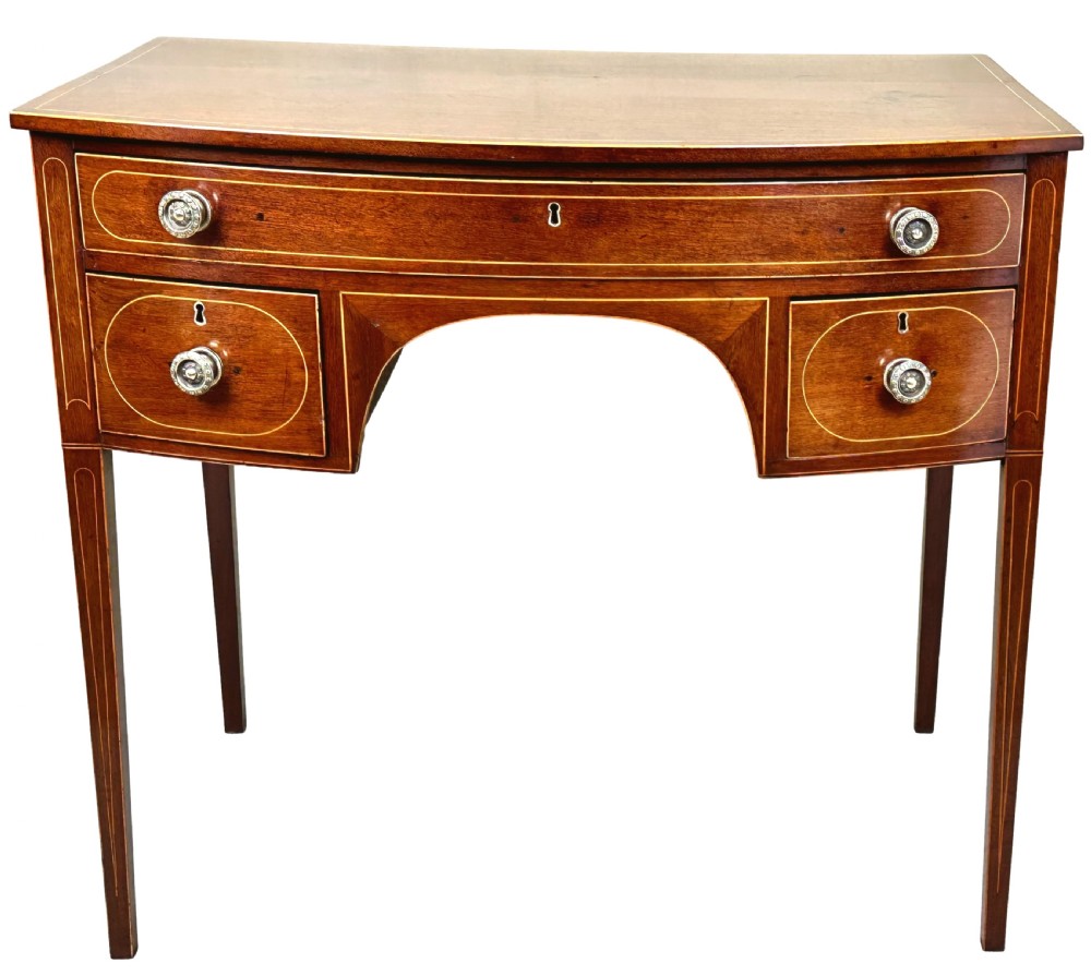 An 18th-century Georgian mahogany dressing table featuring decorative boxwood stringing, three drawers with circular knobs, an arched kneehole, and square tapered legs. View IX