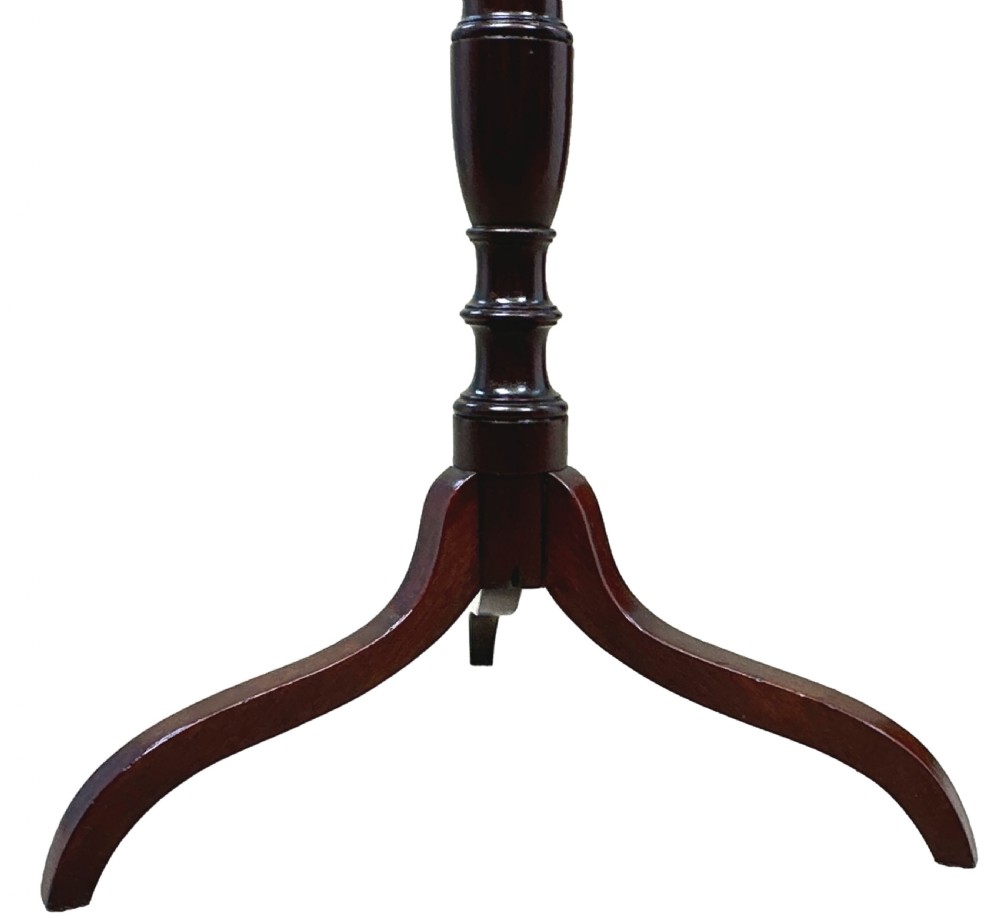 A tall George III mahogany torchere candle stand featuring a scalloped gallery top, turned column shaft, and splayed tripod legs. View IV